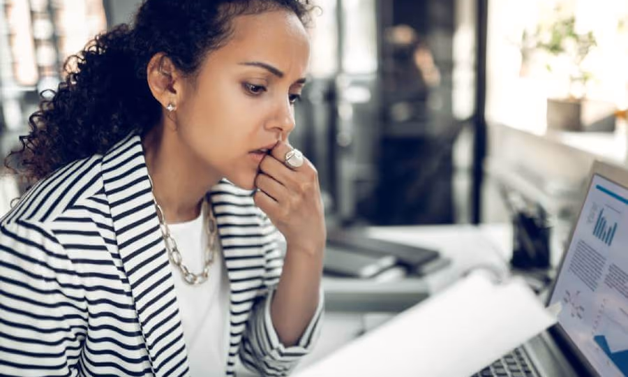 Woman reviewing a document & researching the existence of a Will