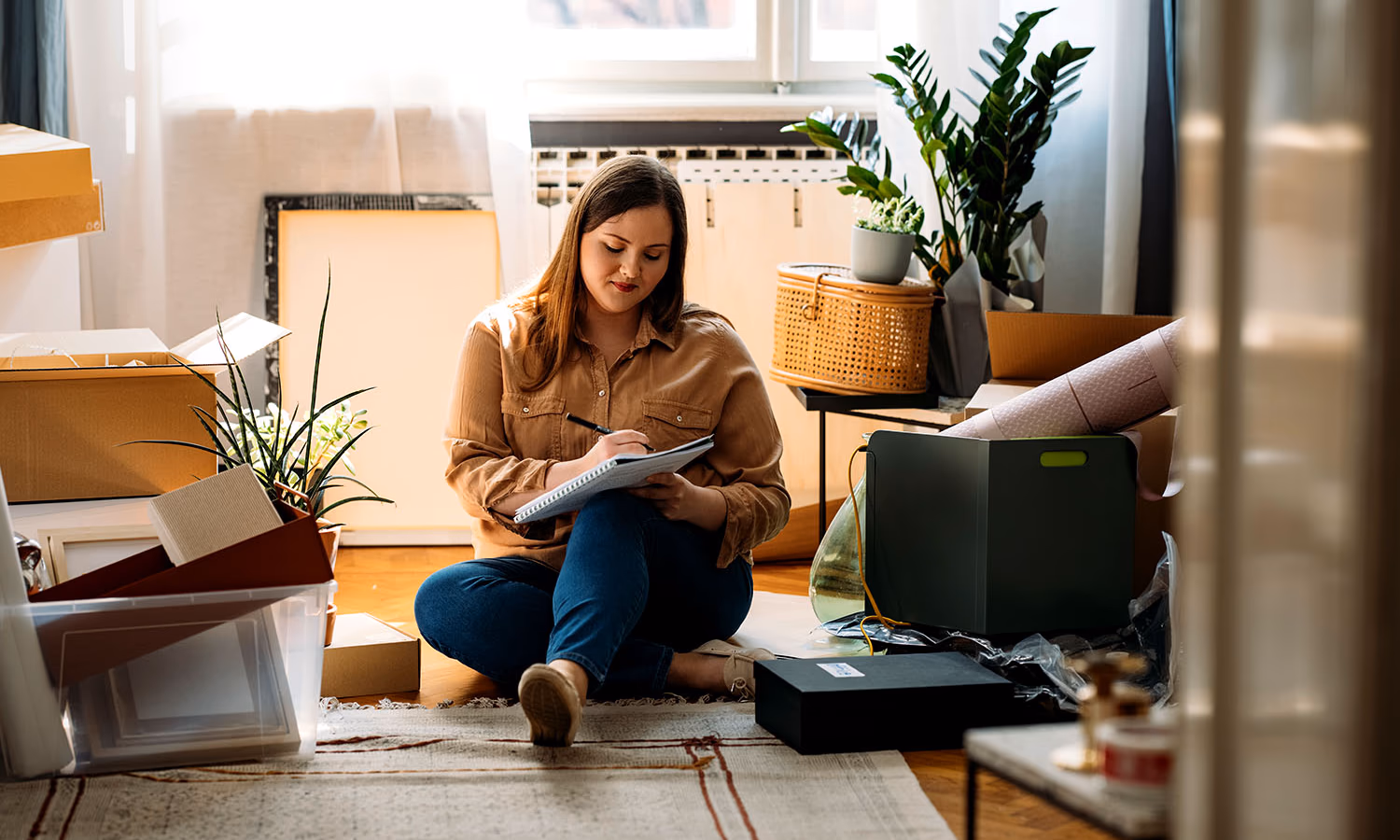 A woman sitting in her living room planning to use a quitclaim deed.