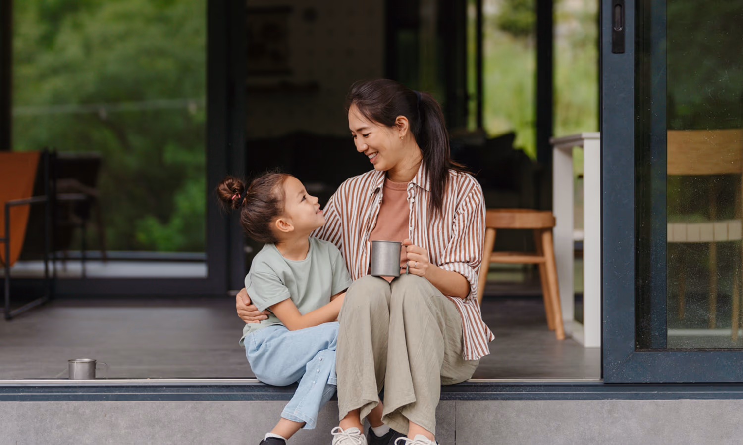 A mother and daughter sit on their front step, talking about when probate is required.