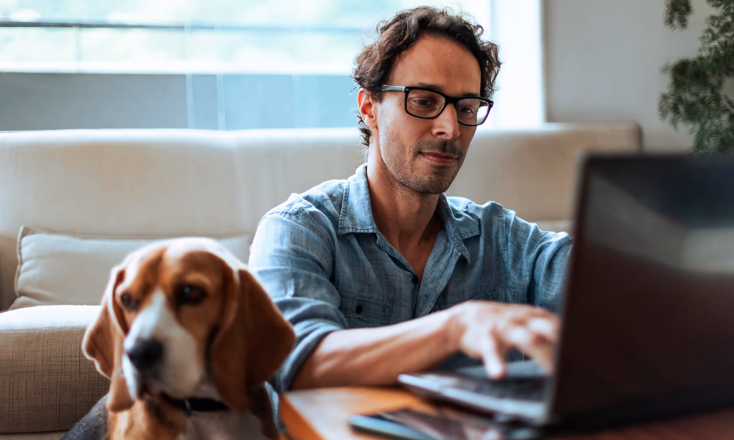 A man works on a laptop