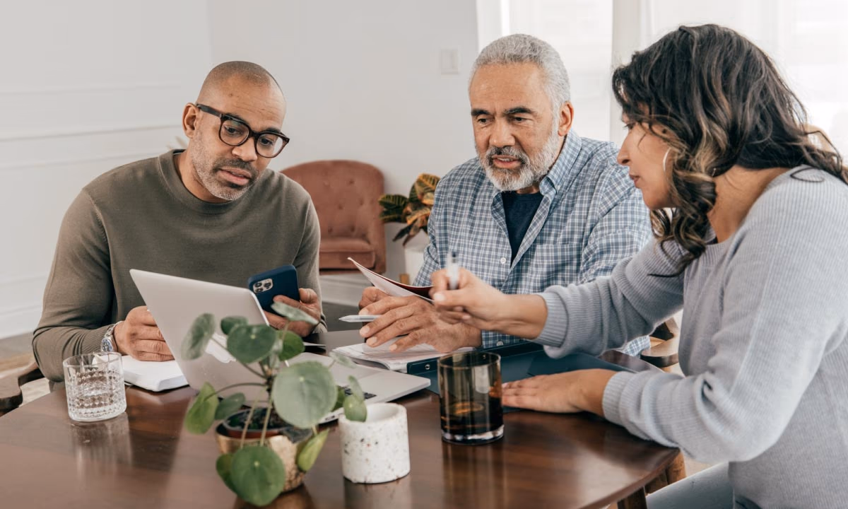 A family sitting around a table reviewing estate documents