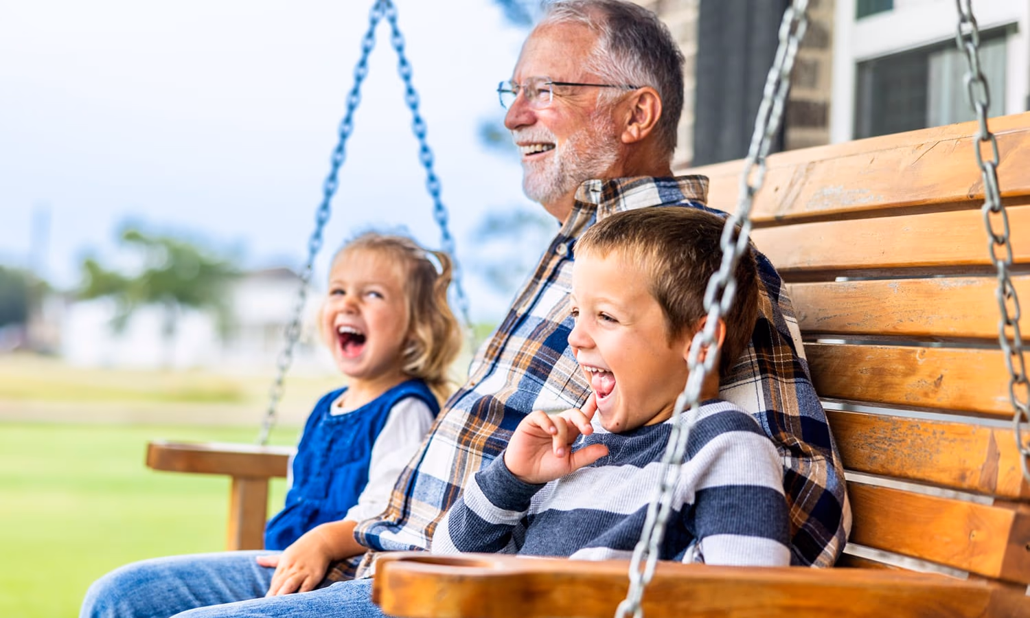 A grandfather sitting with his grandchildren