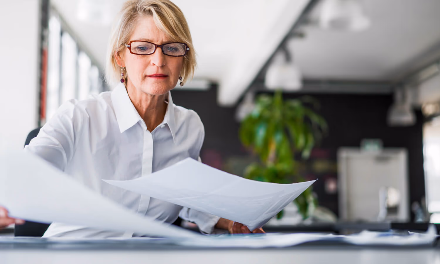 A woman reviewing business records
