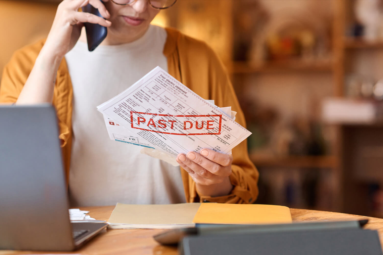 Unrecognizable woman holding past due bill