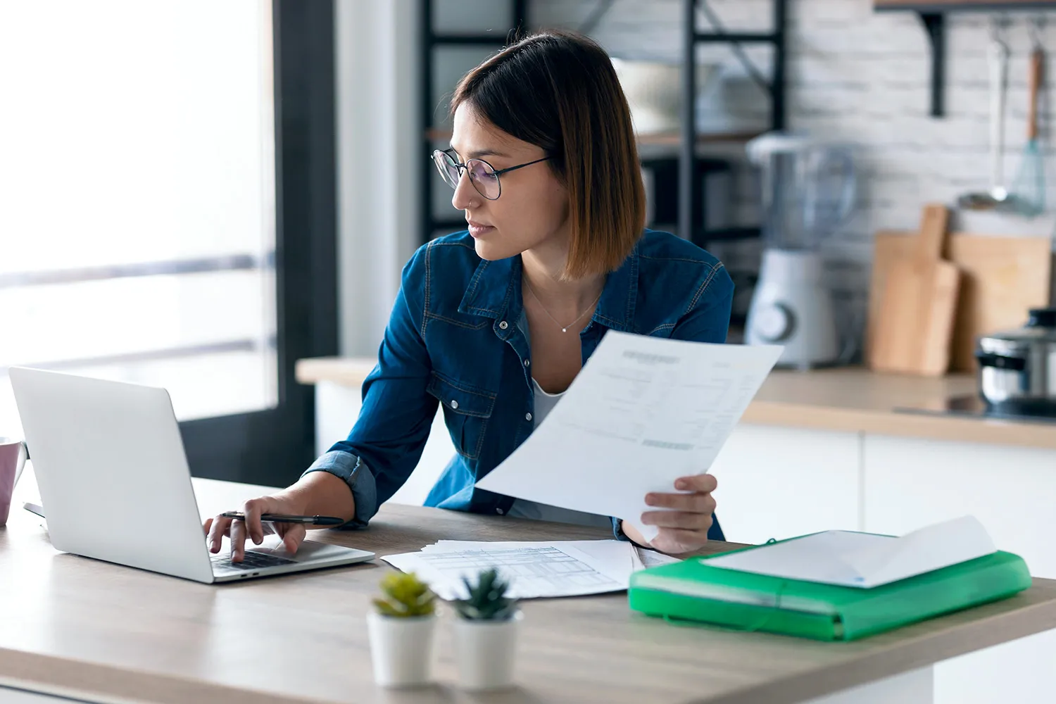 A woman working on a laptop, researching legal separation vs. divorce.