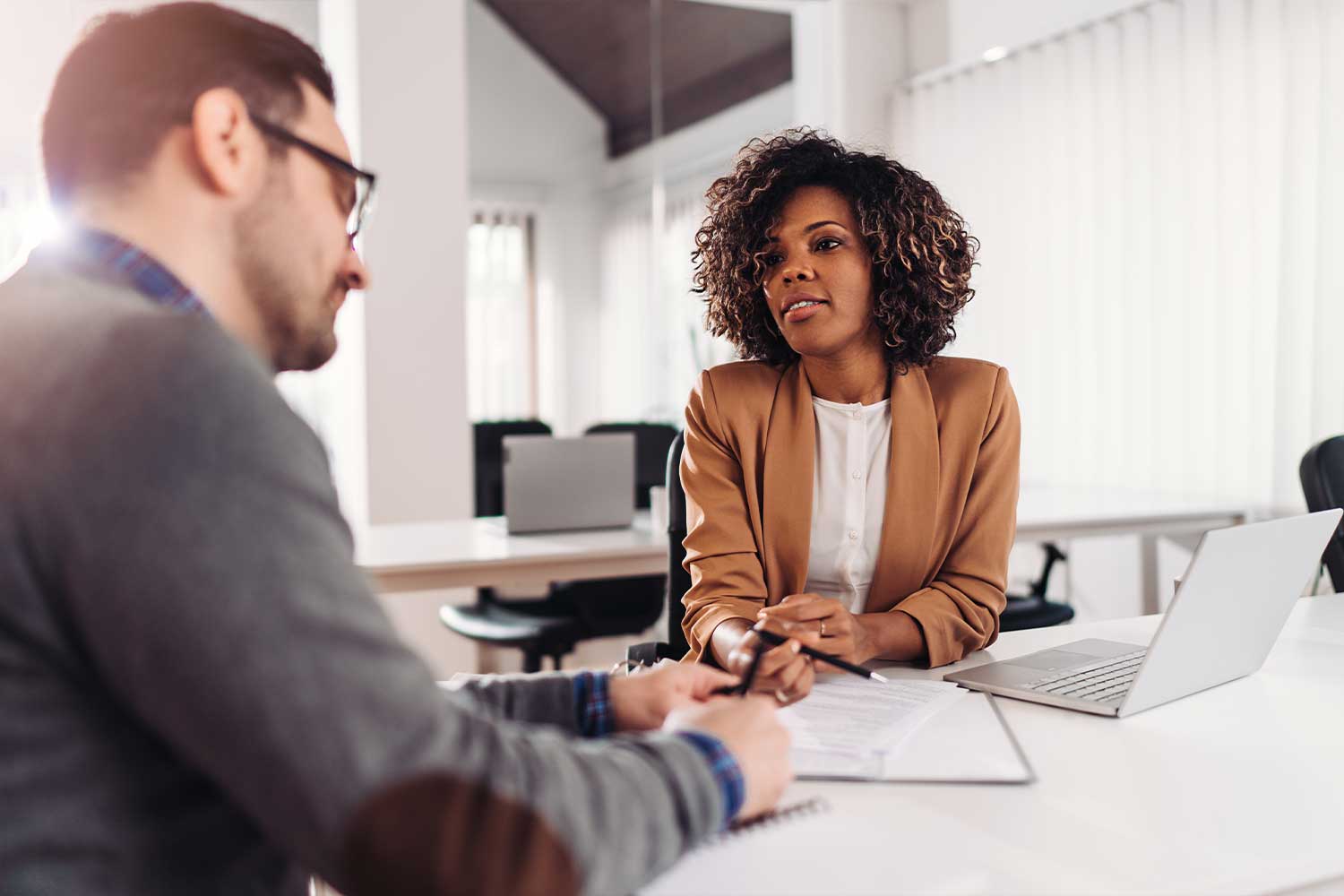 One professional explains a document to another in an office setting