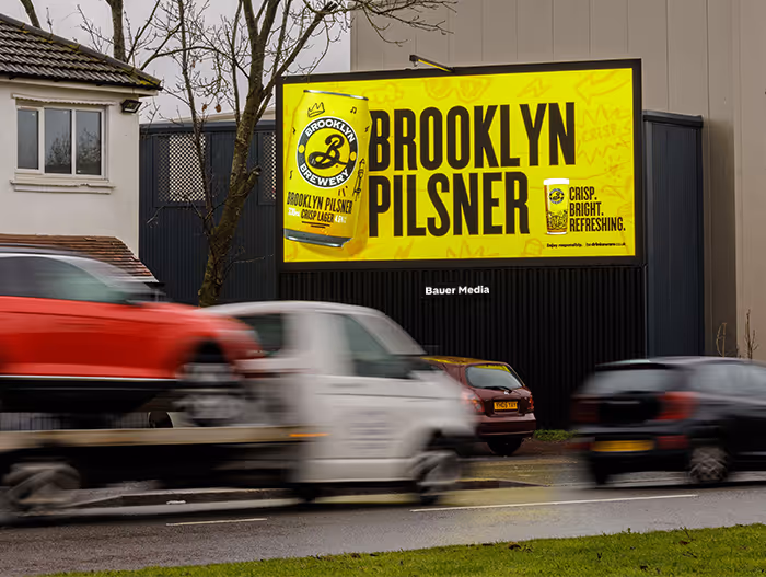 Brooklyn Pilsner digital billboard with cars driving past
