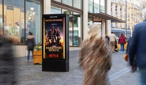 A digital screen on a high street with a Netflix campaign displayed