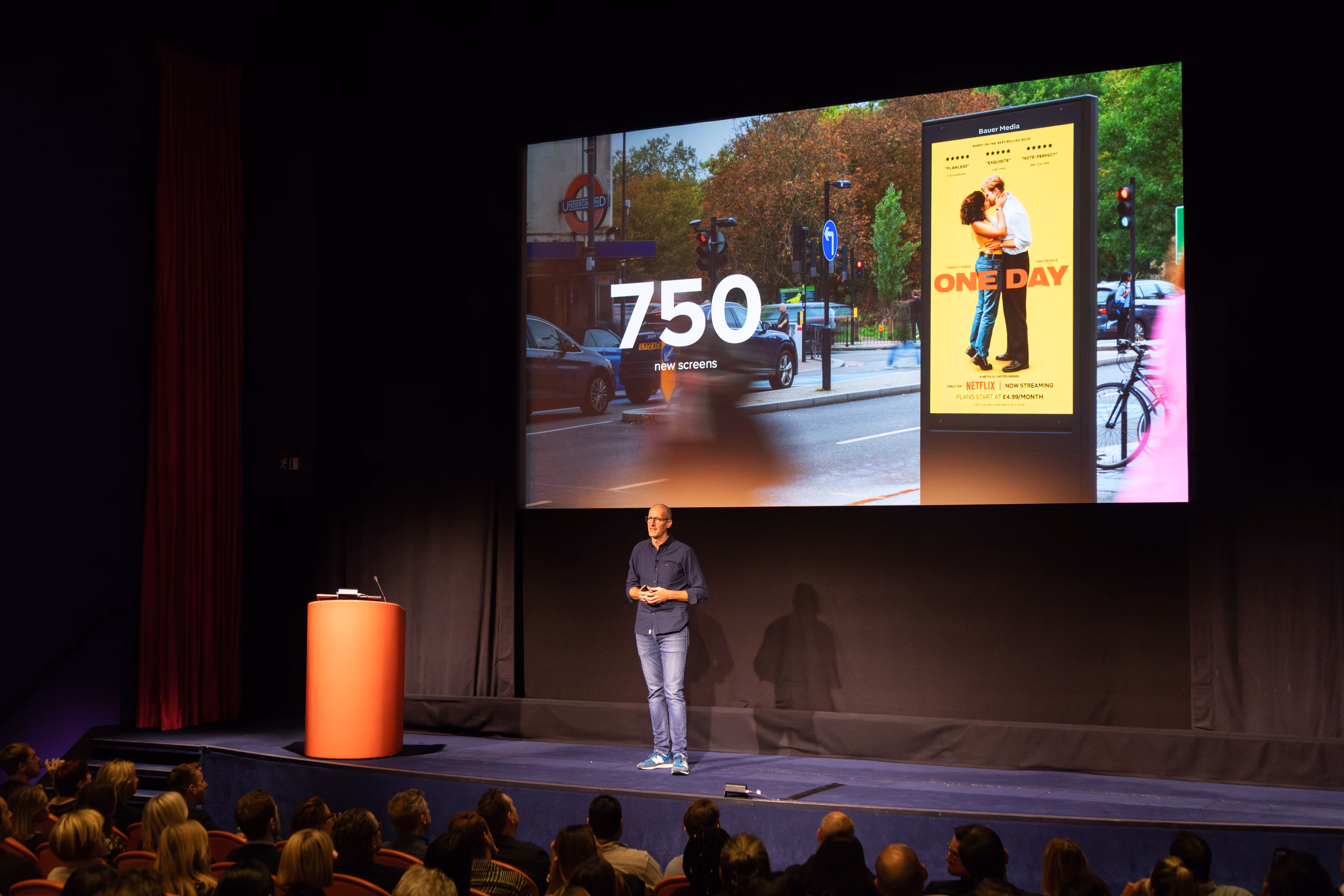 Bauer Media Outdoor's UK Managing Director Richard Bon presenting on stage at an Upfront event