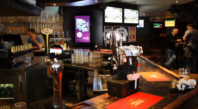 A Socialite digital advertising screen in a bar