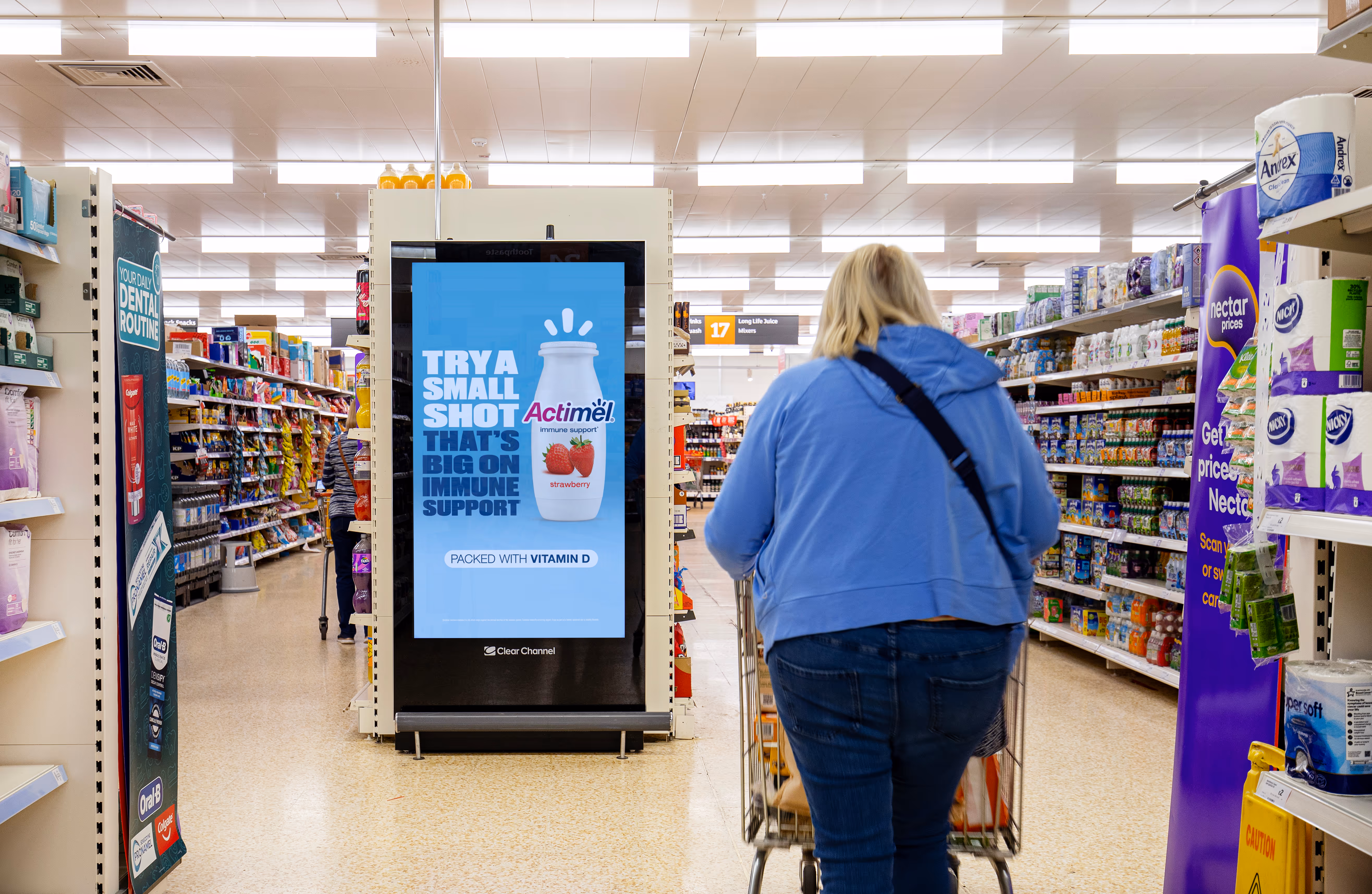 Actimel ad on a digital screen inside Sainsburys supermarket