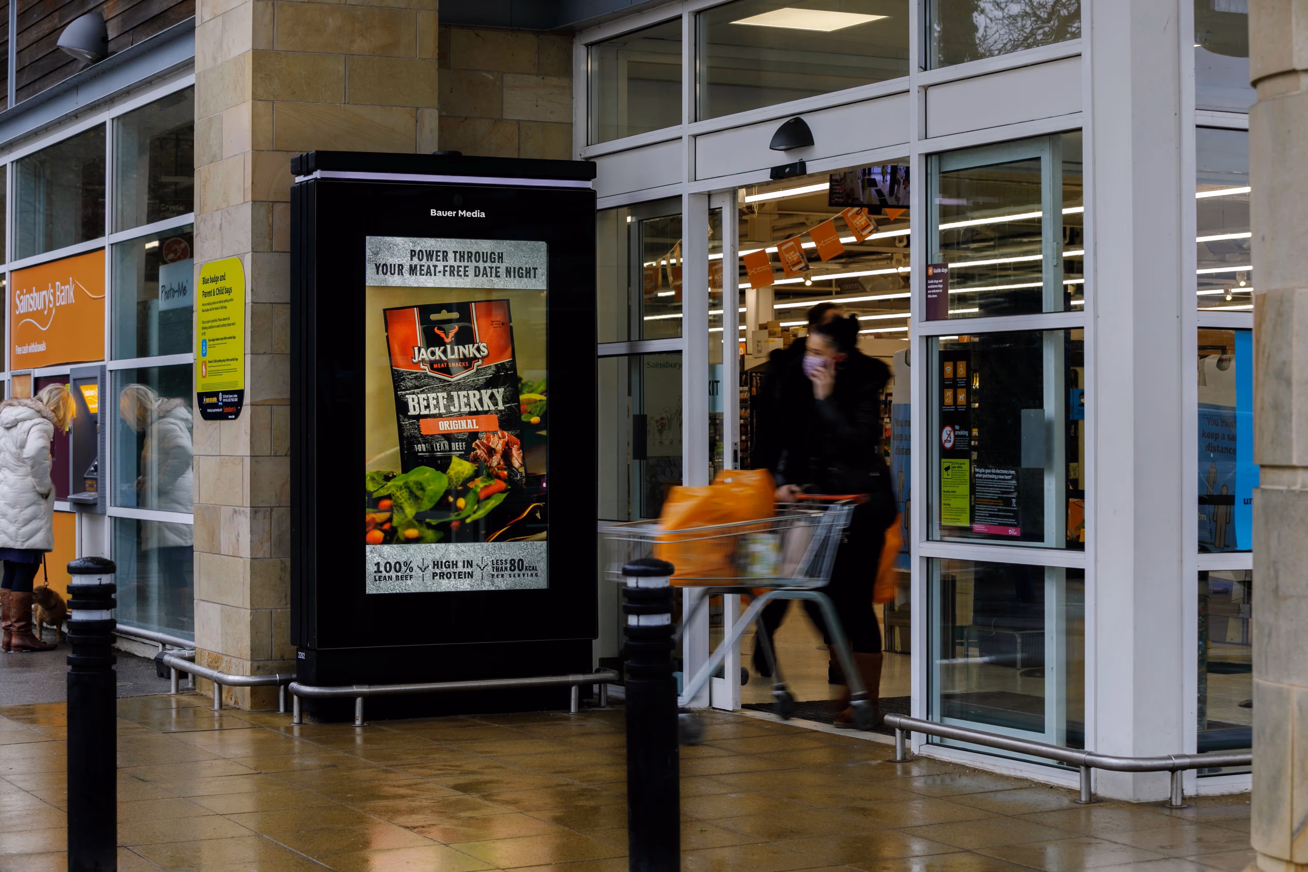 A beef jerky ad campaign outside the entrance of a Sainsbury's supermarket