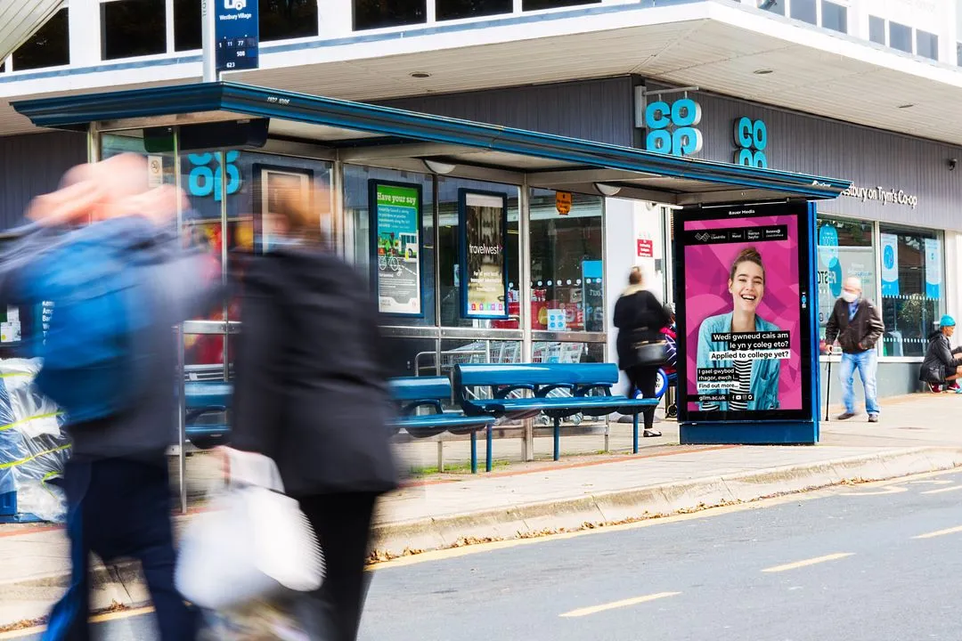 North Wales advertising bus stop poster outside of a Coop