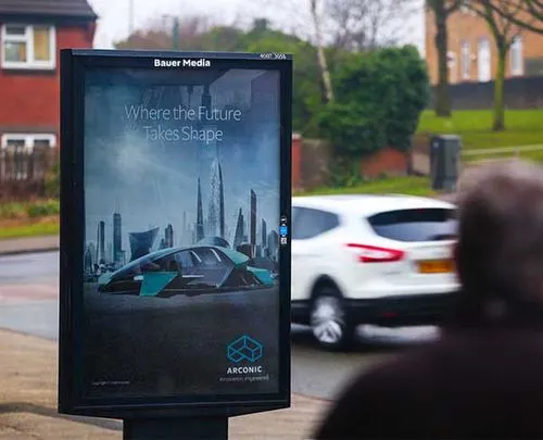 Arconic's ad as a car and person walk past