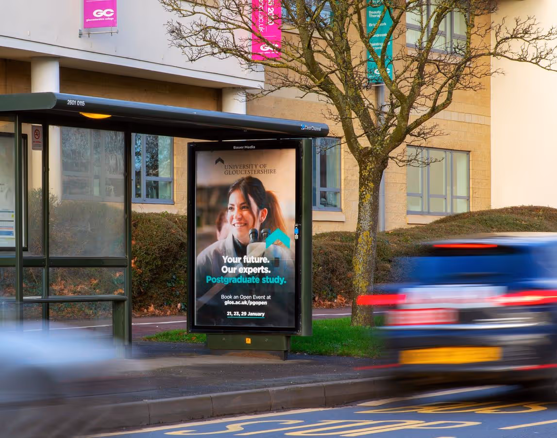University of Gloucestershire's open day Adshel advertisement on a busy road