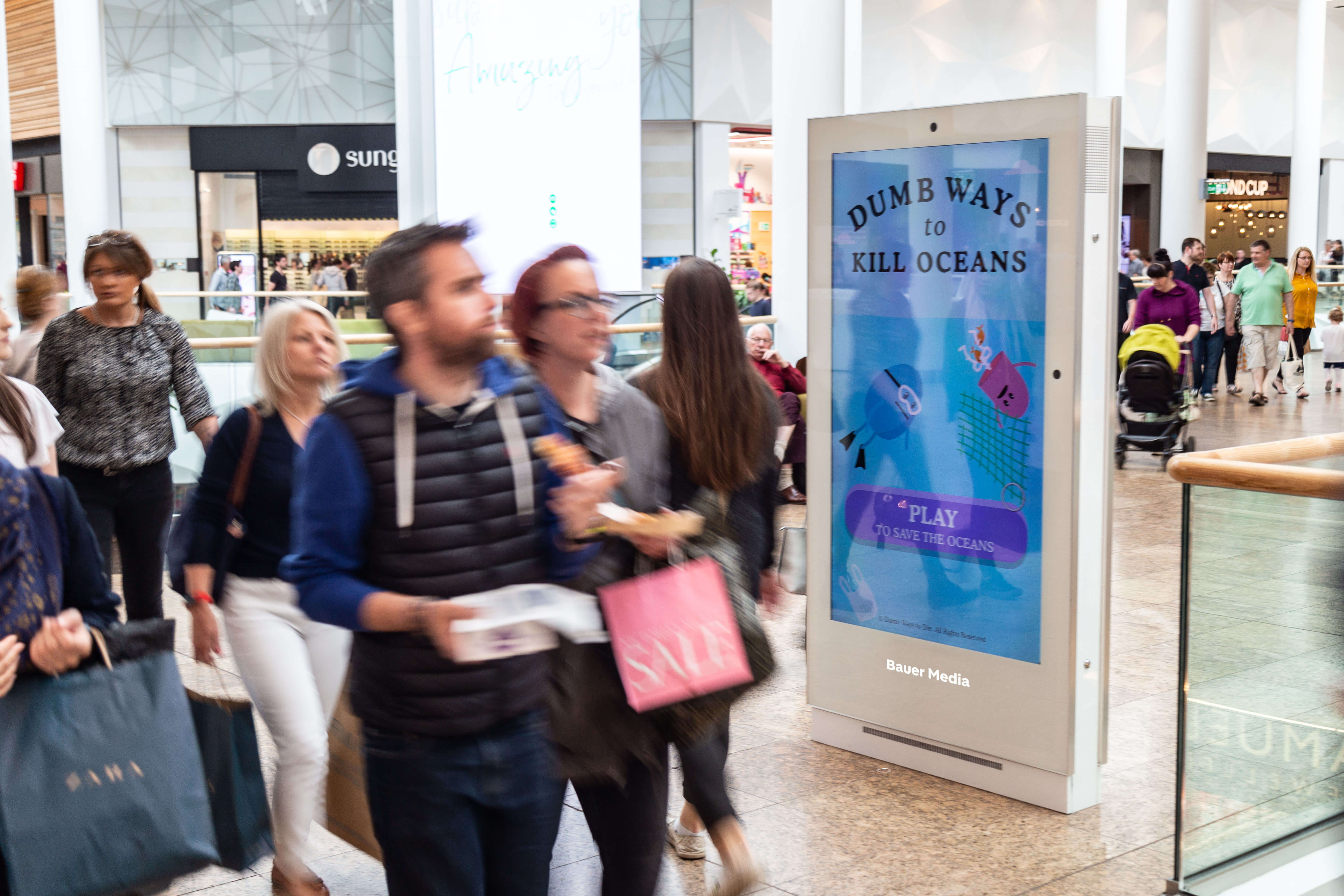 World Ocean Day interactive advert on digital screen in shopping mall with people