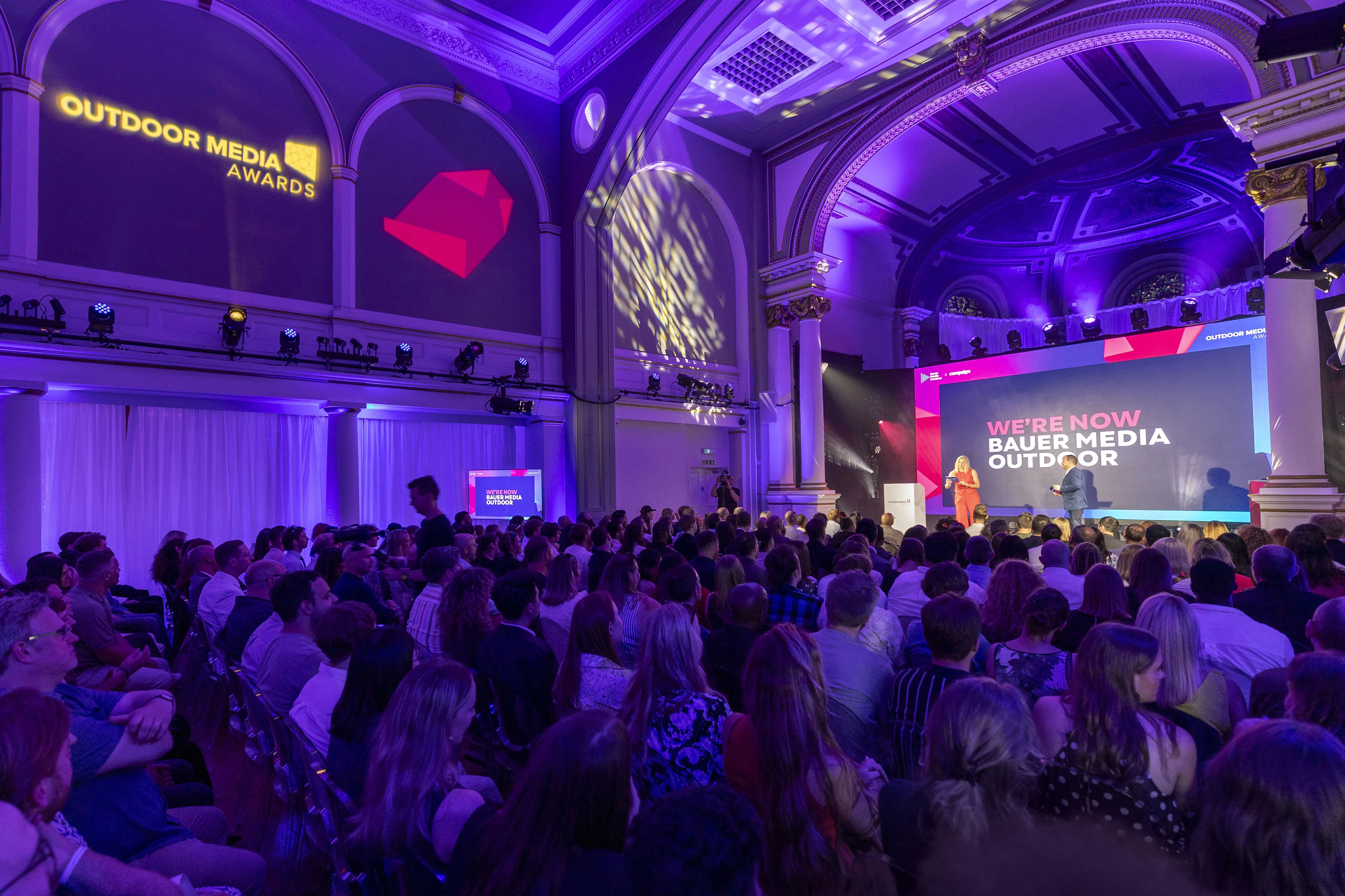 A big event space with purple wash lighting.