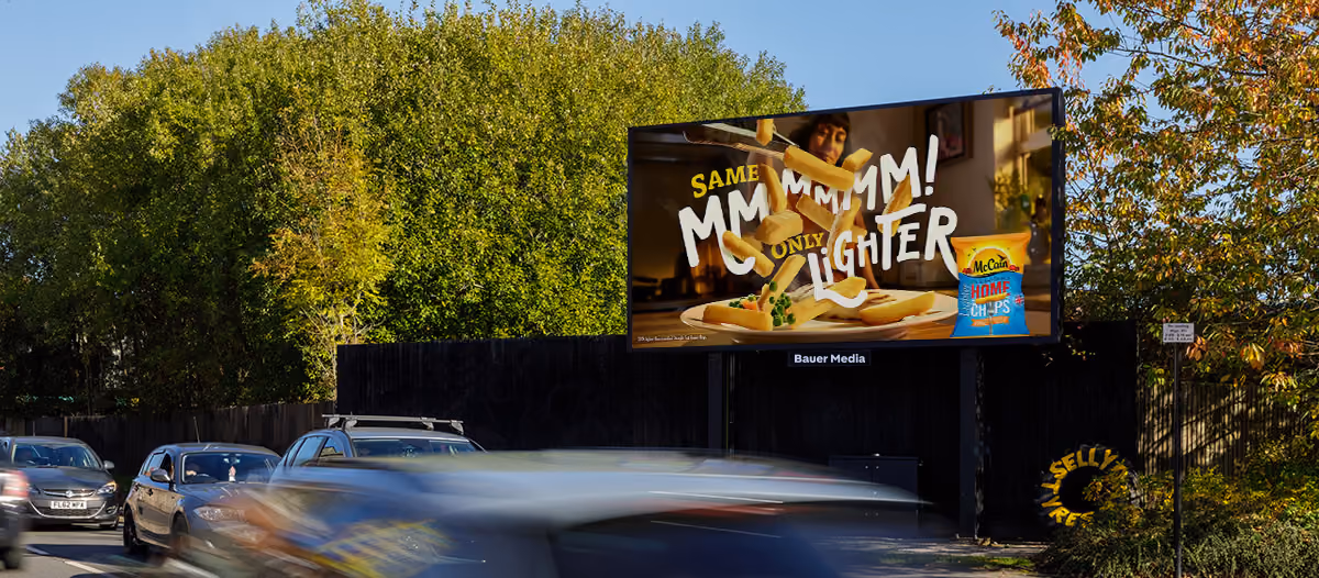 Outdoor digital billboard showing McCain Home Chips with the text 'Same MMMM! Only Lighter' above fries on a plate.