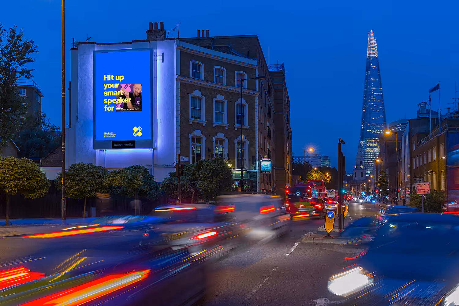 Storm Borough High Street advertising screen at night with a view of the shard in the distance