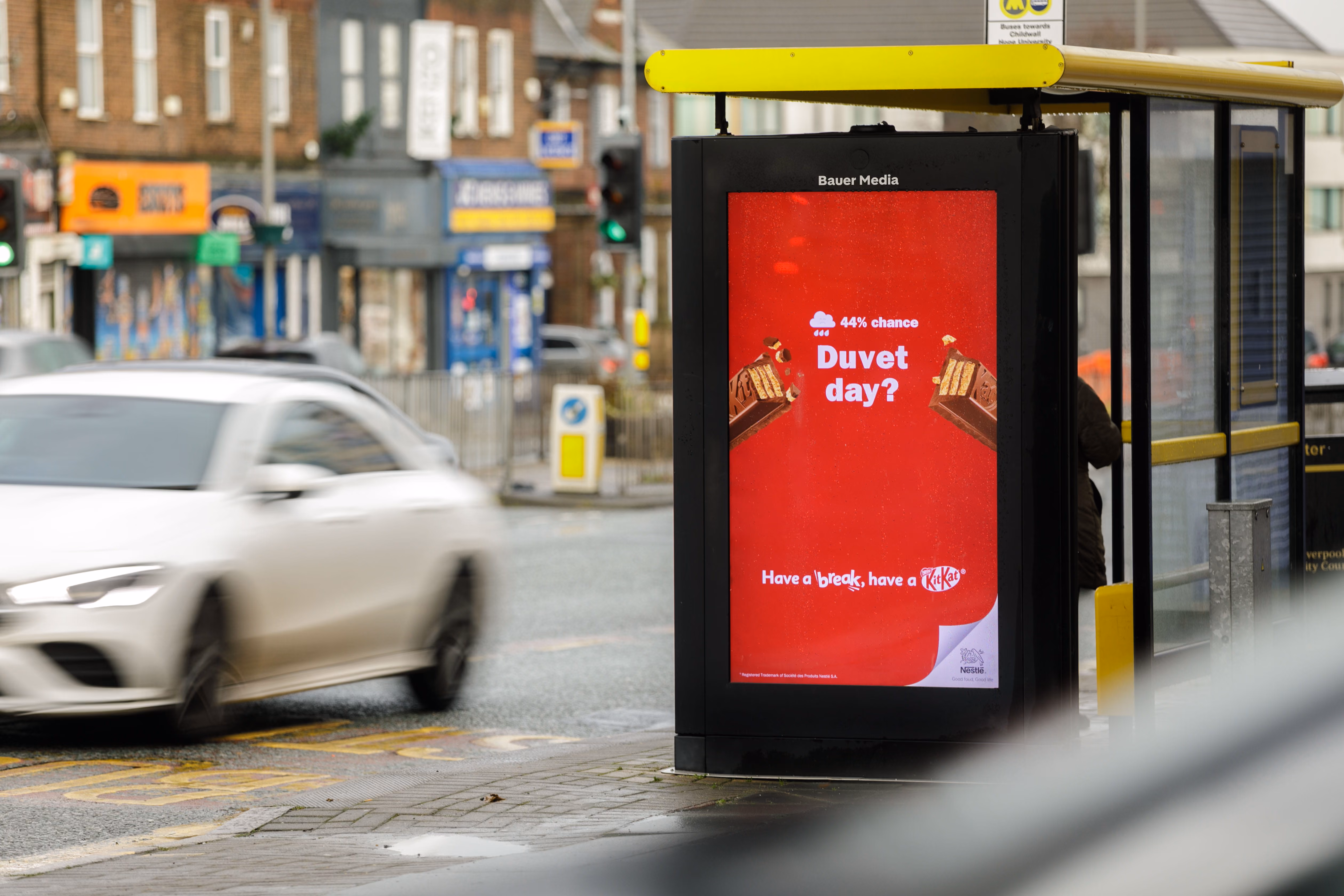Bus stop ad with KitKat on red background reading '44% chance Duvet day? Have a break, have a KitKat.'
