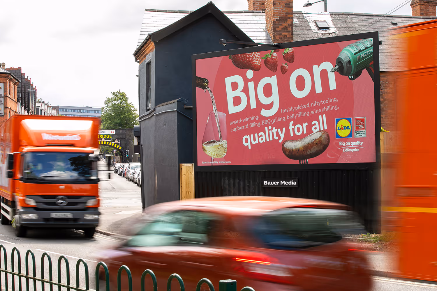 Digital billboard screen next to a busy road