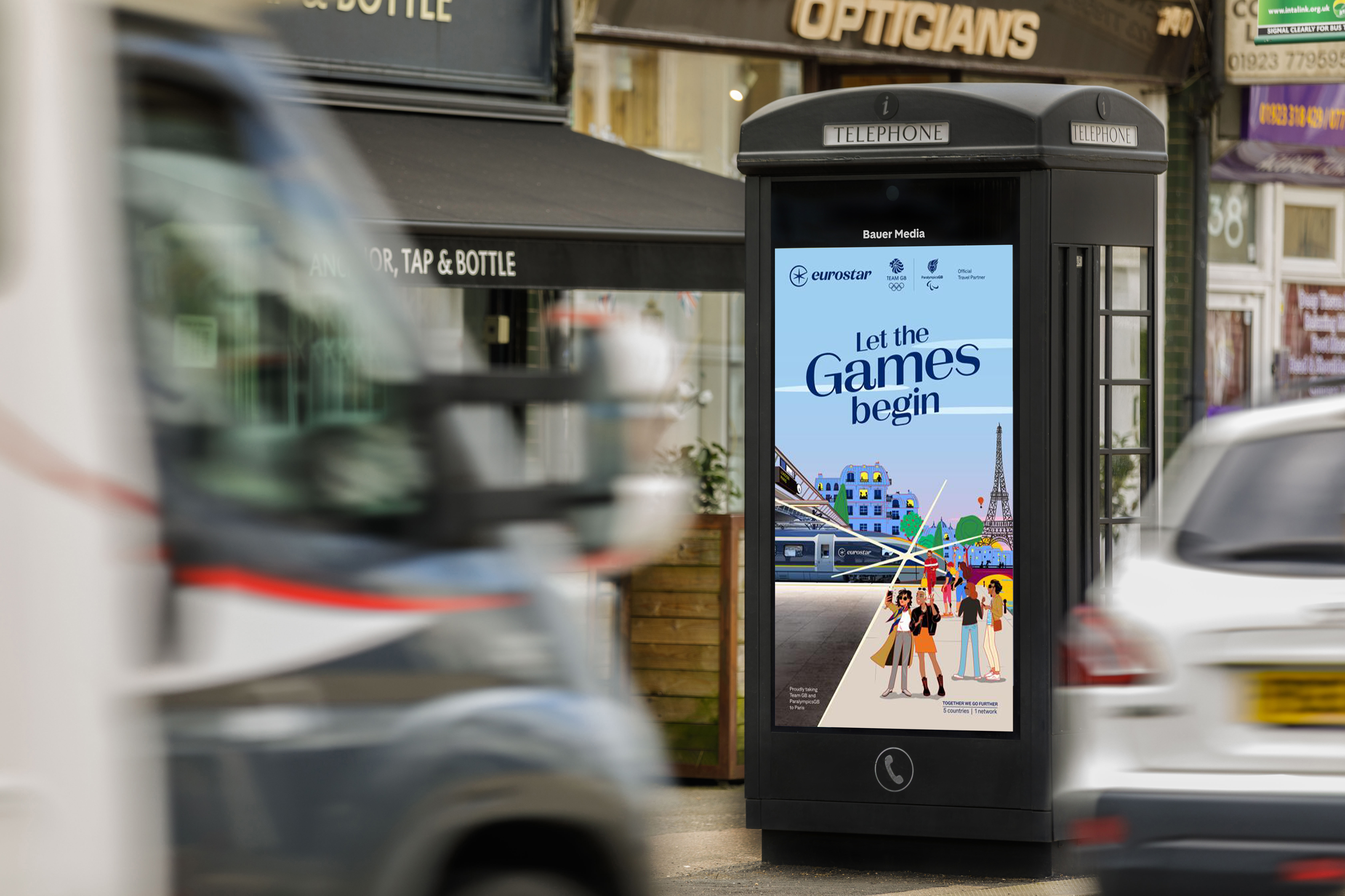 Eurostars advertising on a New World Payphone, on a busy sidewalk, during the day as cars pass by 