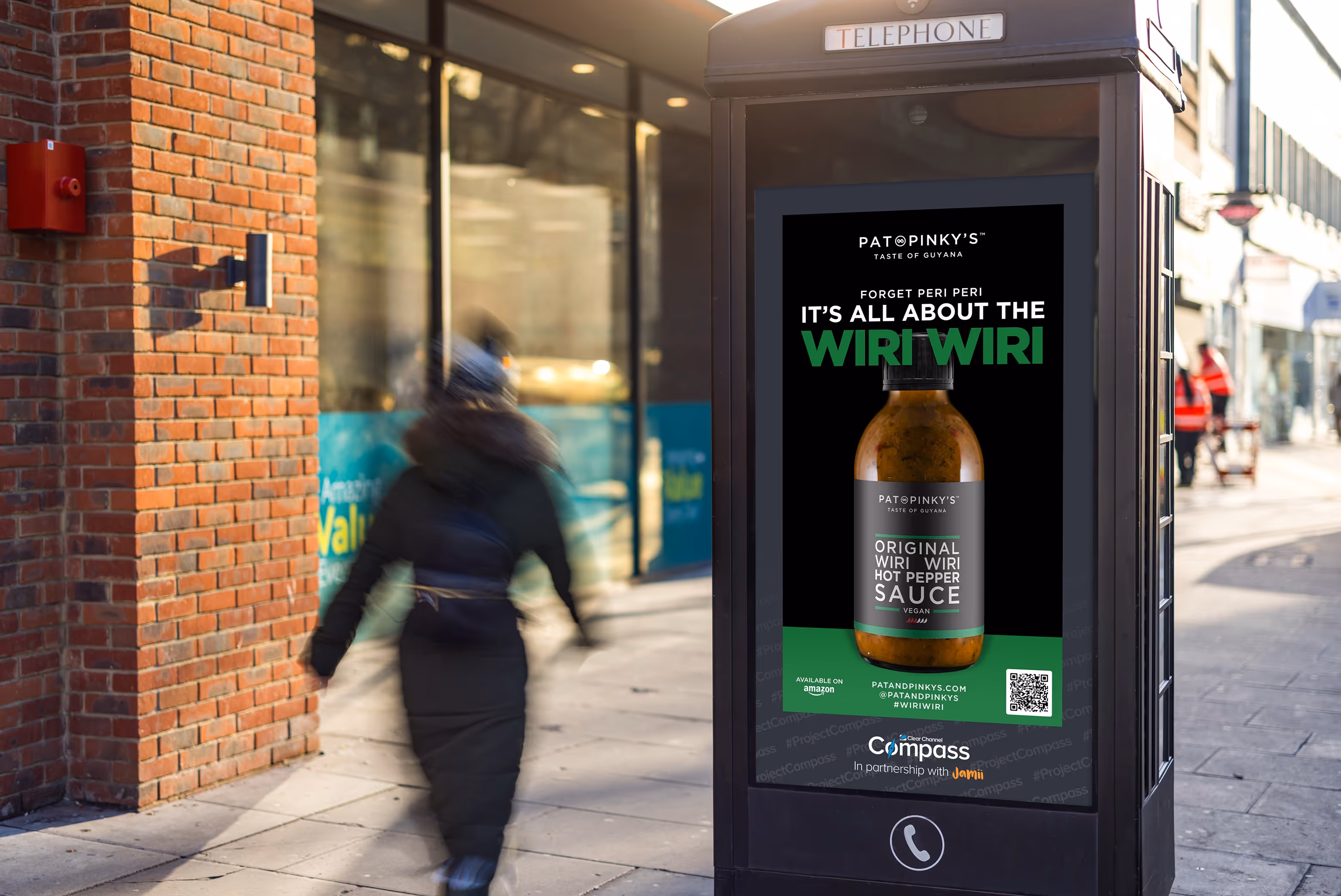 An ad promoting a Black-owned business on a digital screen on a phone kiosk