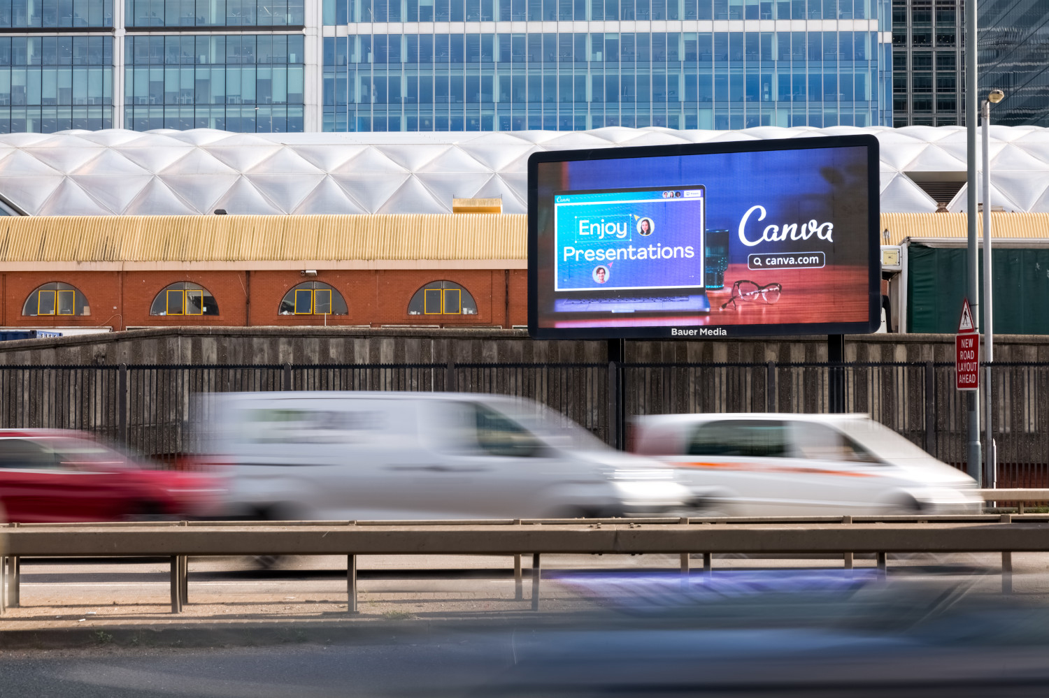 Canva's DOOH advertising campaign with traffic driving in front