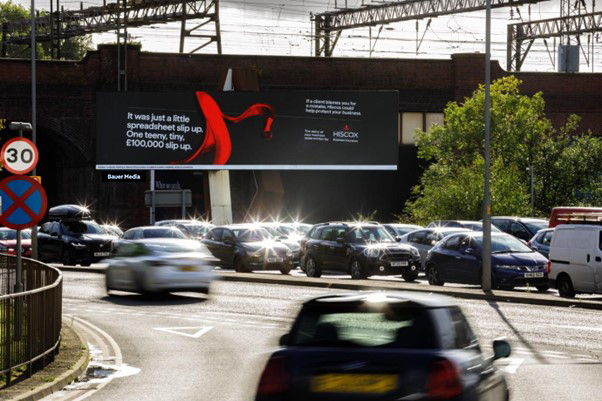 Hiscox advertising on a premium digital billboard in Manchester