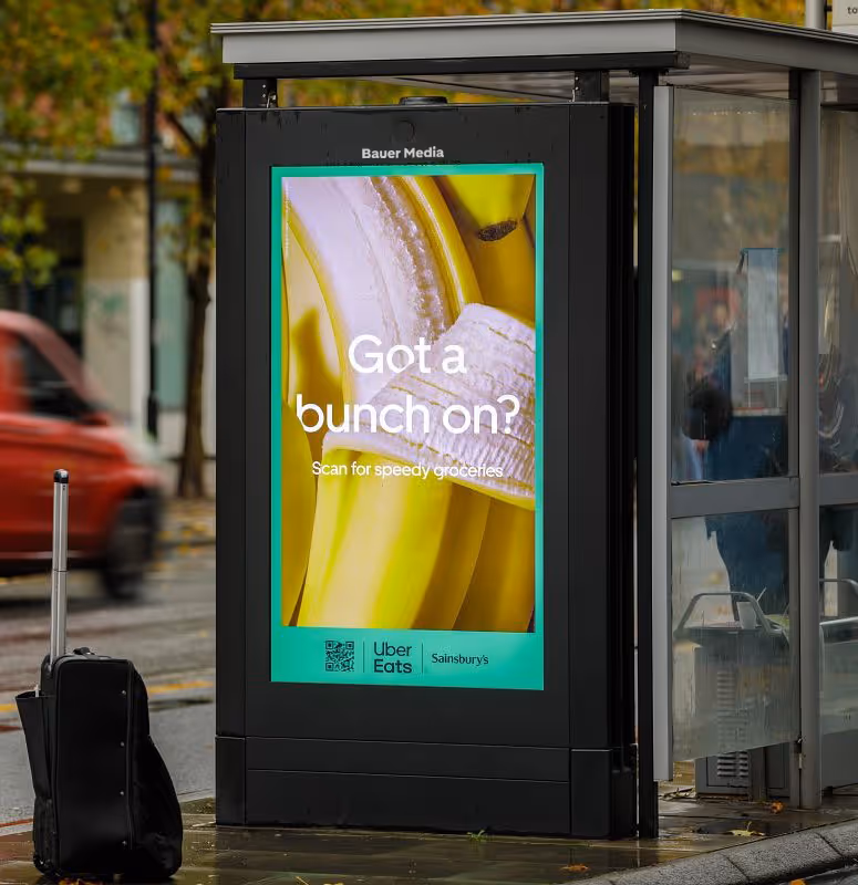 Uber Eats advertising on a digital bus shelter screen