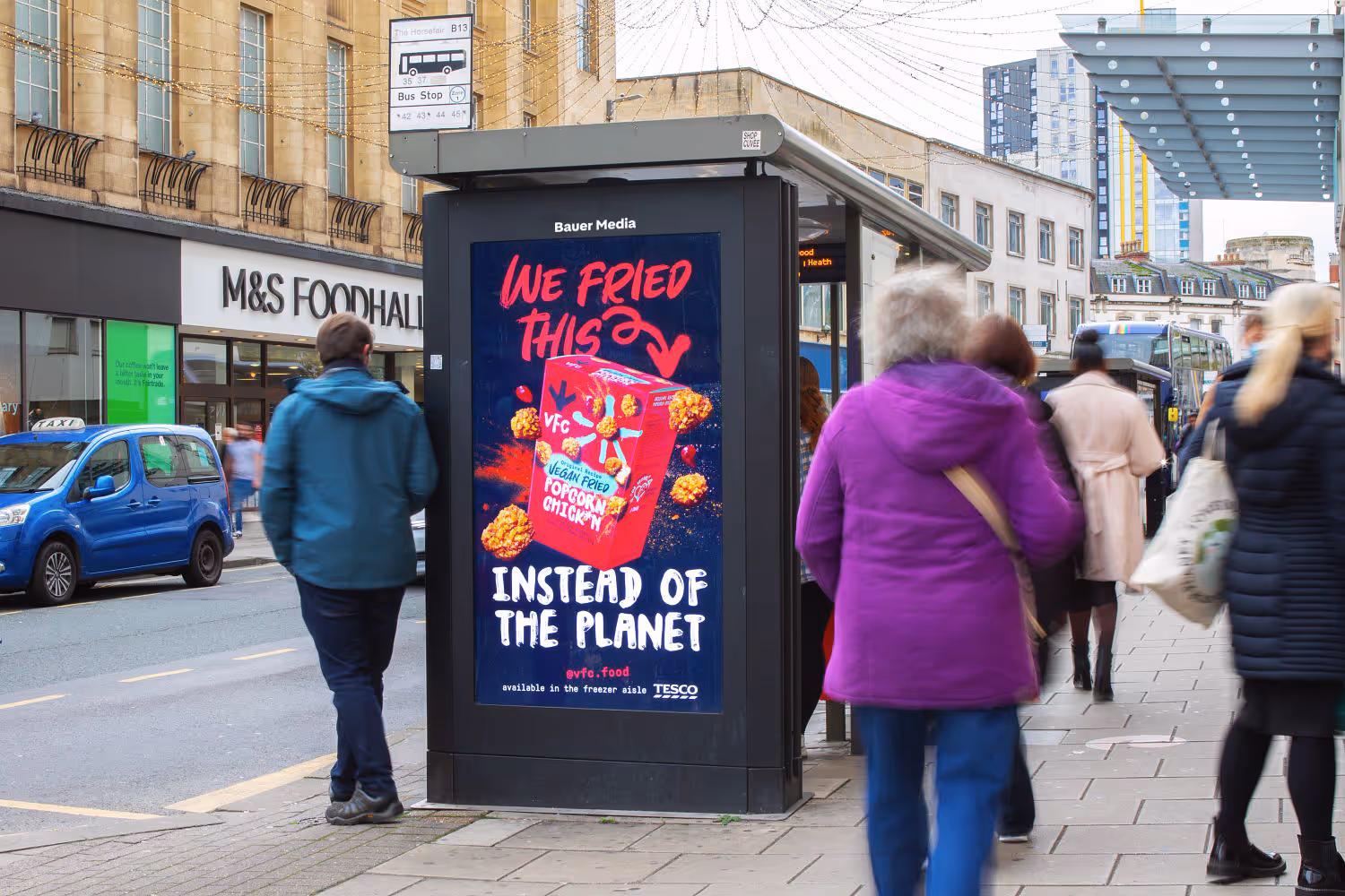 A vegan chicken advert on a digital bus stop screen