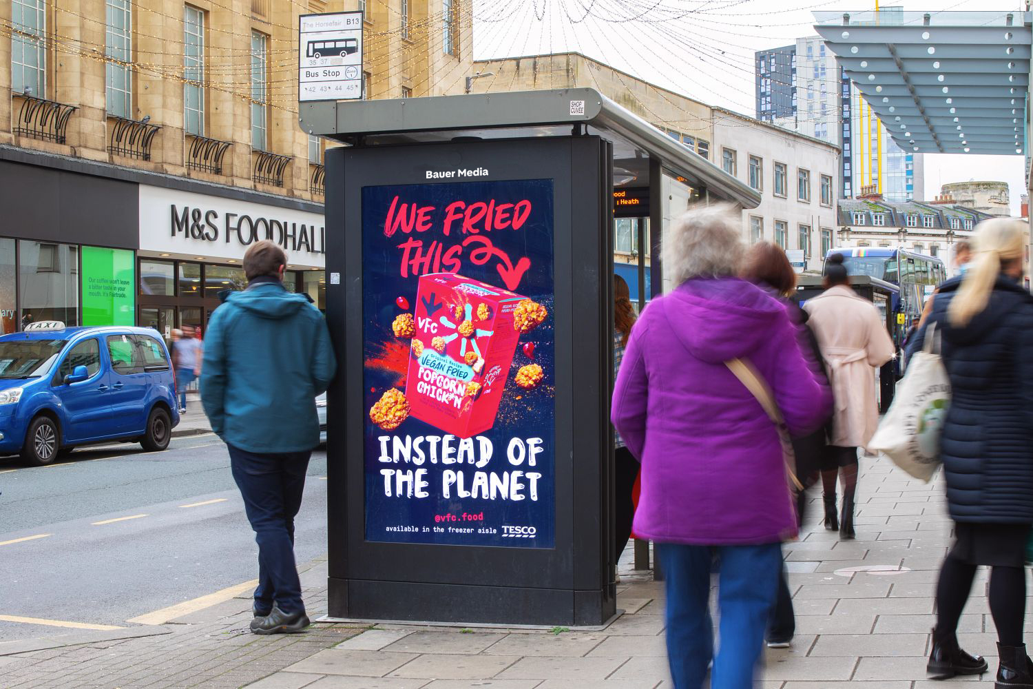 A vegan chicken advert on a digital bus stop screen