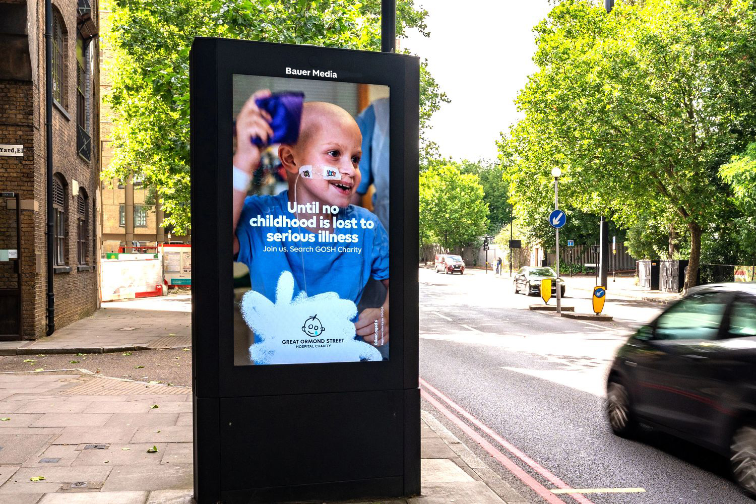 Great Ormond Street advertising on an Adshel Live screen next to the road