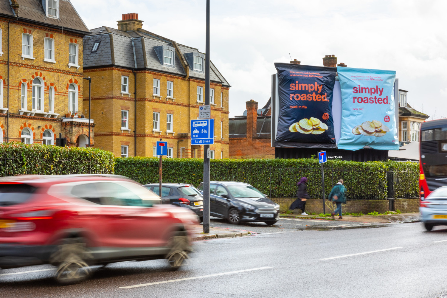 Simply Roasted Special Build campaign display two large, 3D crisp packets on a billboard