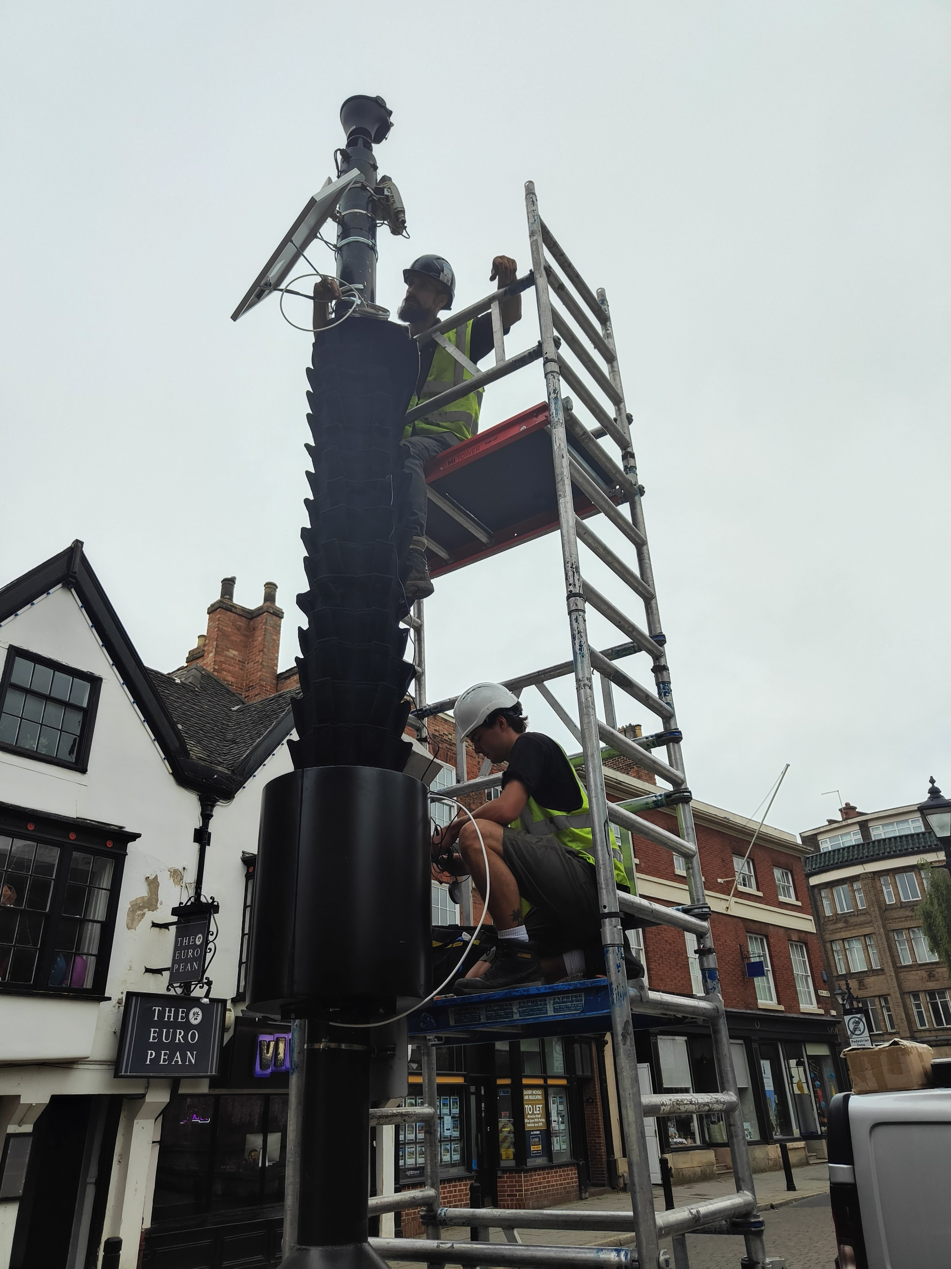 Operatives install Living Pillar to a lamp-post in Derby's city centre