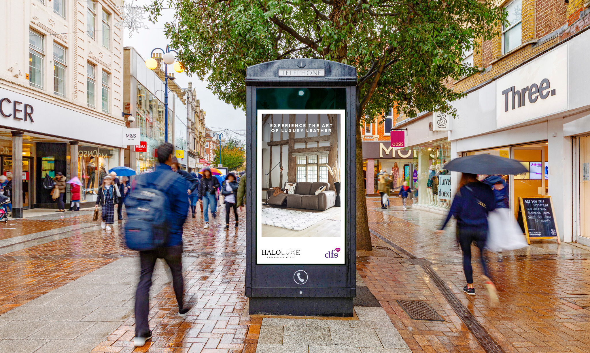 Digital phone box screen outside M&S & Three store showing DFS ad