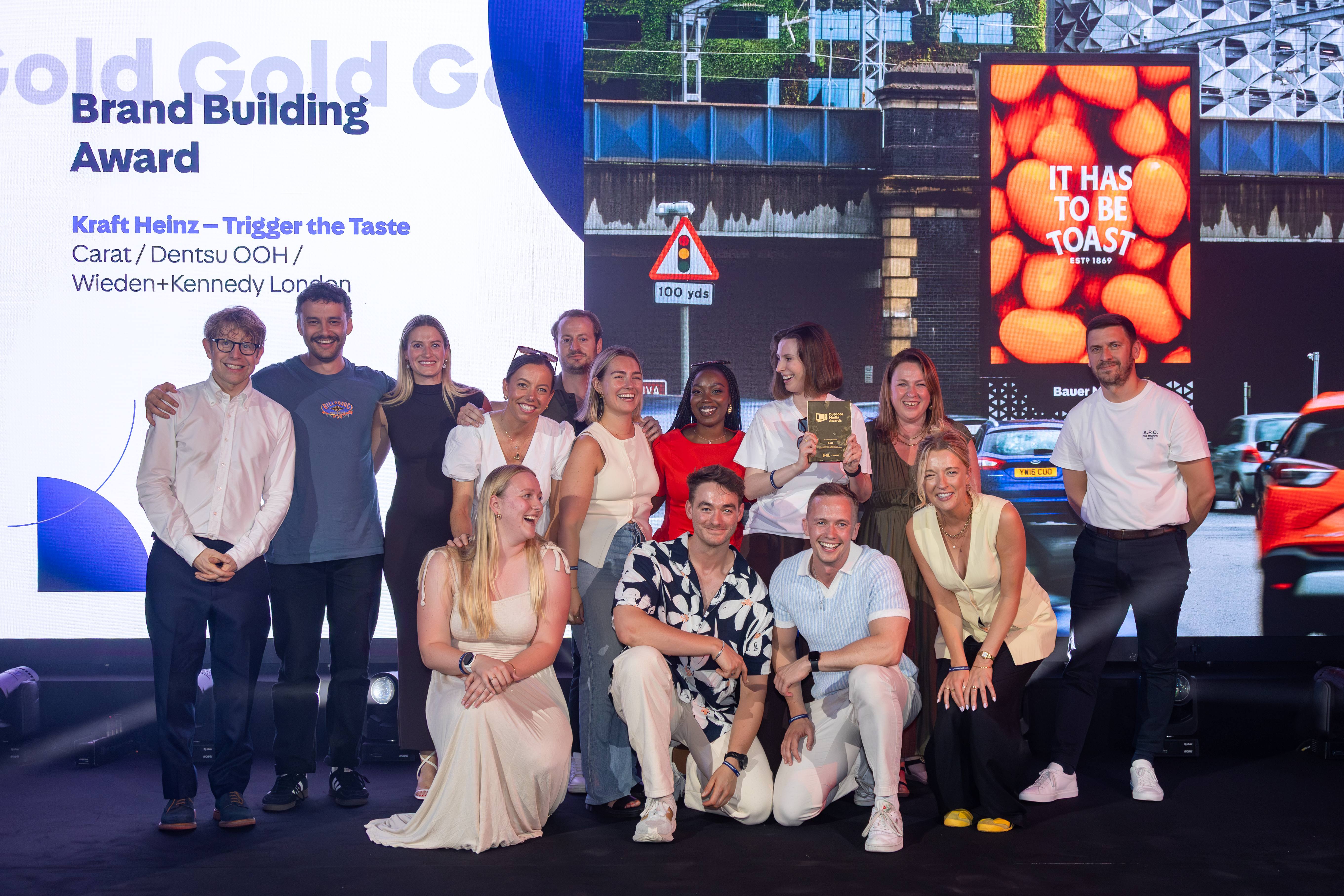 Award winners pose on stage after receiving the Brand Building Award for Kraft Heinz’s “Trigger the Taste” campaign.