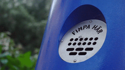 a hand putting out a cigarette butt in the machine, a smoke ring rises from the top of the machine