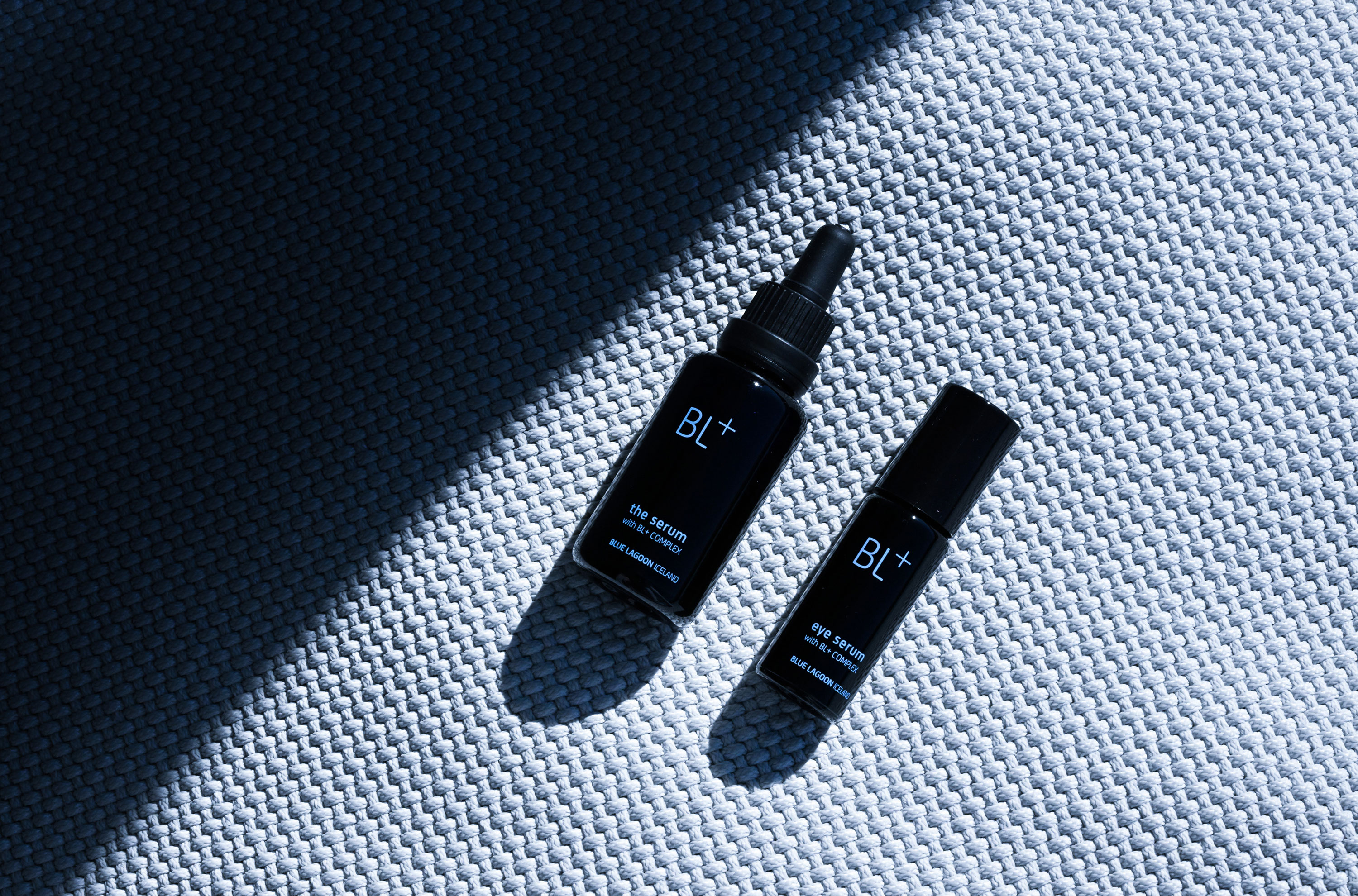 Close-up of a corner of a tablet with a smooth glass screen and rounded edges on a purple surface.