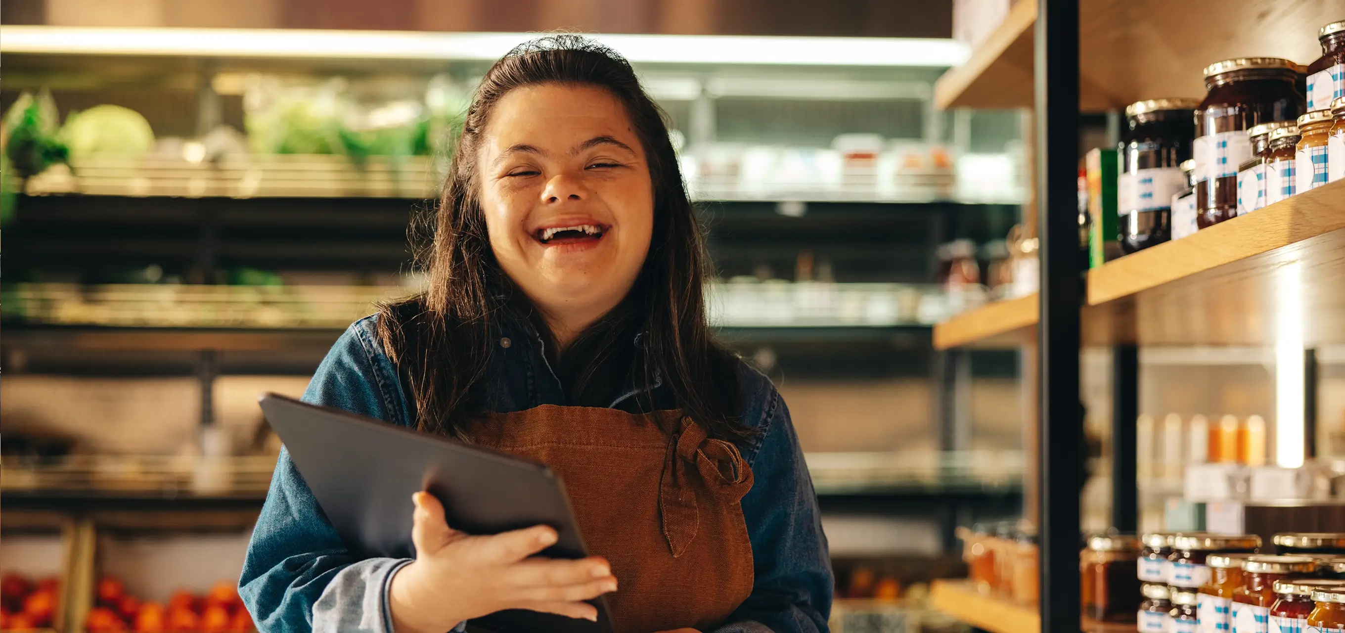 Woman with a tablet working in a supermarket.