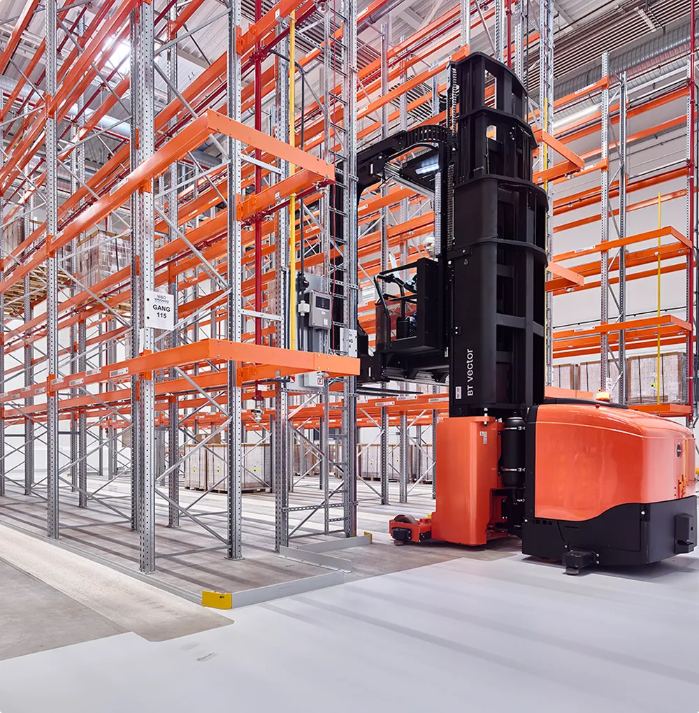 High-bay warehouse with an orange-black warehouse robot that lifts a shelf compartment.