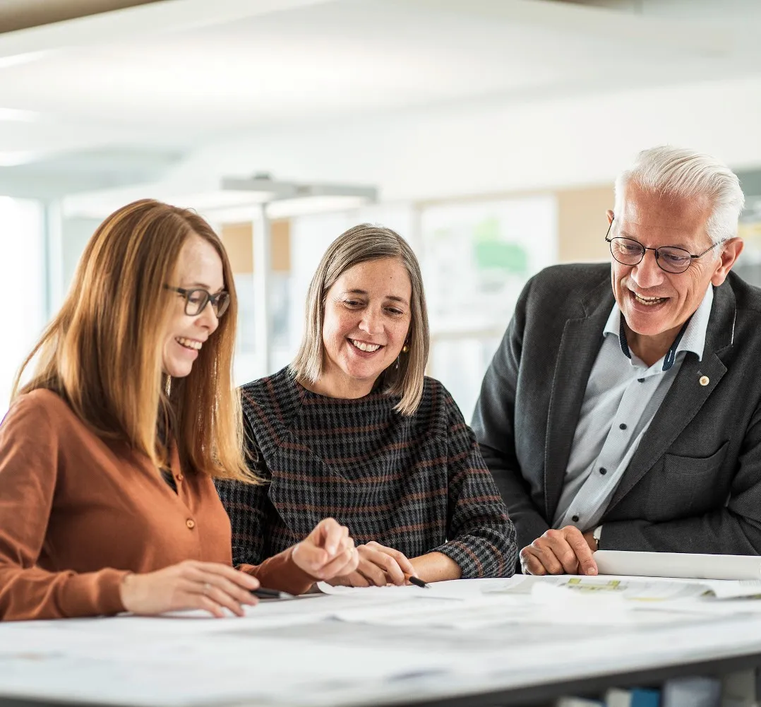 Three people are discussing a plan.
