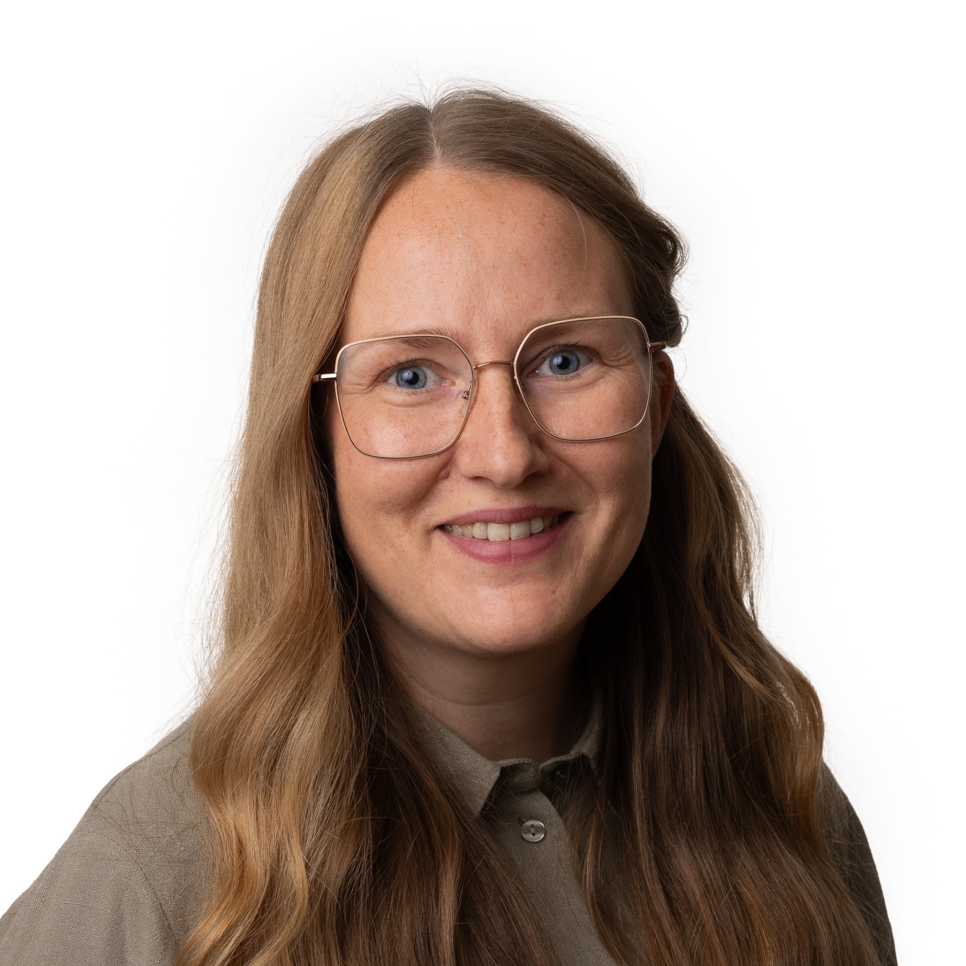 Smiling woman with long light brown hair, wearing large square eyeglasses and a buttoned shirt.