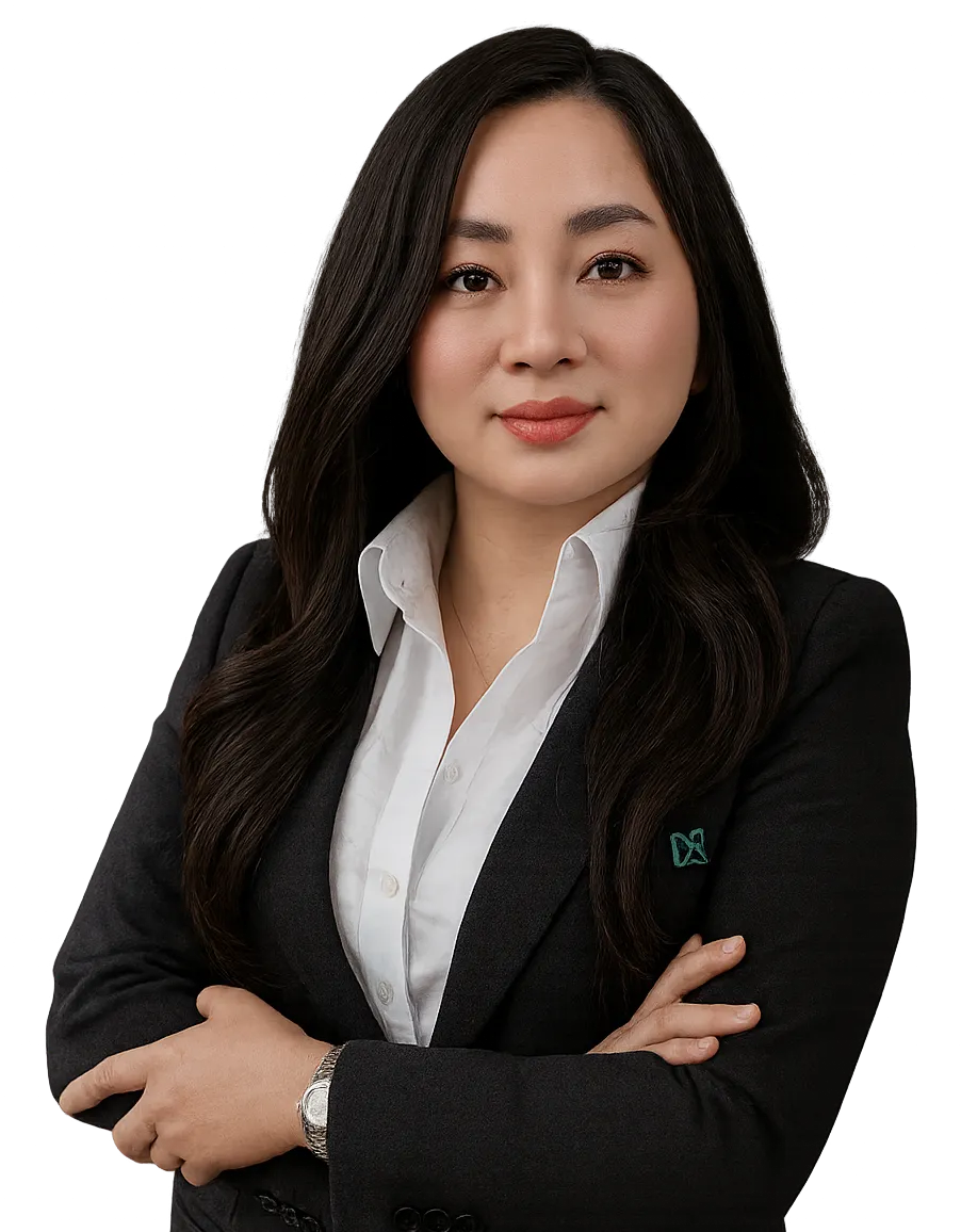 Confident woman with long dark hair wearing a black blazer over a white shirt, arms crossed.