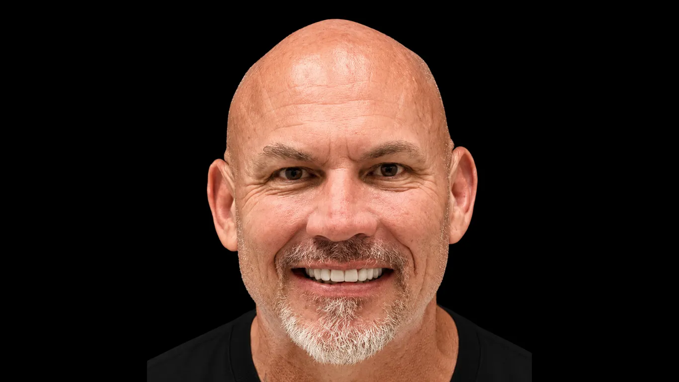 Smiling man with a full, natural-looking smile after bone grafting and implant treatment at Makris Dental Prosthodontics