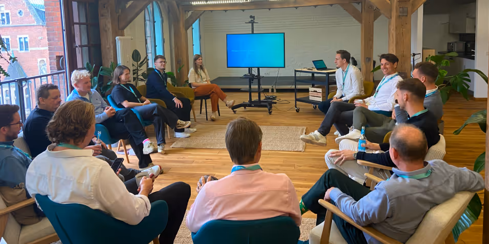 Group of people sitting in a circle at a shipzero event