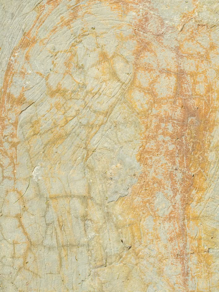 Faded ancient rock painting featuring abstract human and animal figures in earthy tones of red, orange, and beige with visible cracks and texture on the stone surface.