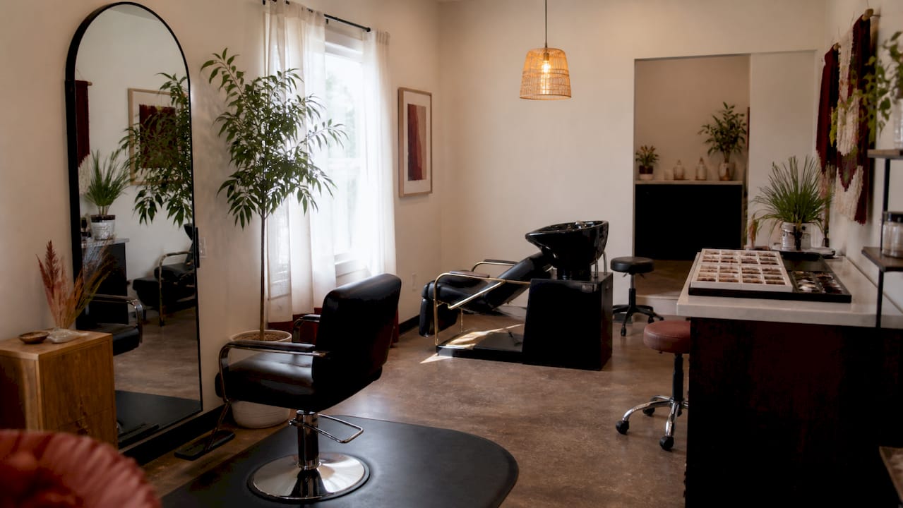 Salon suite with shampoo bowl and styling area