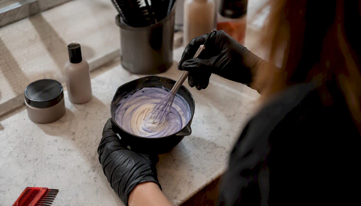 Hair stylist mixing color in bowl