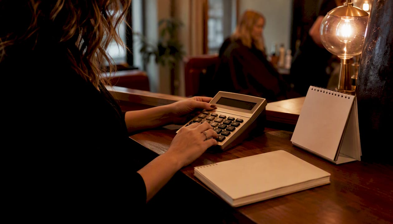 Stylist hands calculating tiered commissions